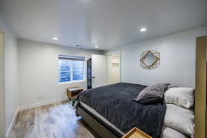 Bedroom featuring wood finished floors and recessed lighting