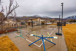 Surrounding community with a mountain view, community basketball court, and a residential view