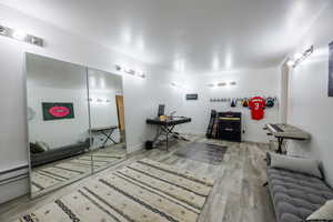 Living area featuring light wood-style flooring and a desk