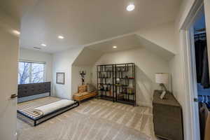 Carpeted bedroom with recessed lighting and vaulted ceiling
