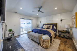Bedroom featuring vaulted ceiling, dark wood finished floors, a ceiling fan, access to outside, and recessed lighting