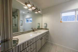 Full bathroom featuring vanity, a shower stall, and light tile patterned floors