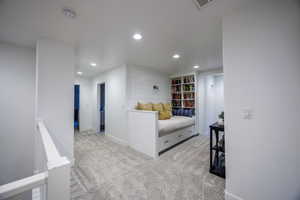 Bedroom with recessed lighting and light colored carpet