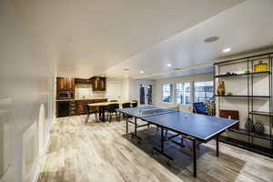 Playroom with light wood-style flooring and recessed lighting