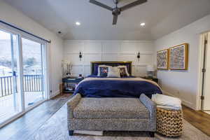 Bedroom with access to outside, wood finished floors, vaulted ceiling, recessed lighting, and ceiling fan