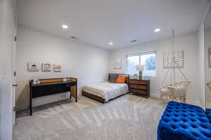 Carpeted bedroom with baseboards and recessed lighting