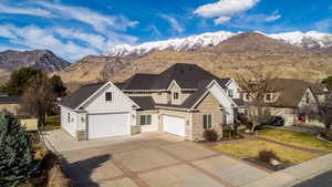 View of front facade featuring stone siding, a mountain view, and board and batten siding