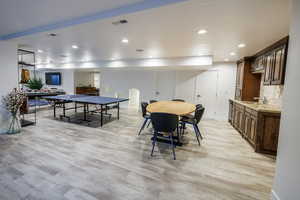 Rec room with recessed lighting and light wood finished floors