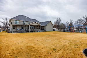 Rear view of property featuring a patio and ceiling fan