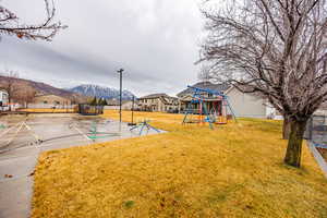 Community play area with a trampoline and a mountain view