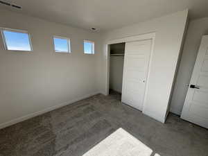 Unfurnished bedroom with carpet floors and a closet