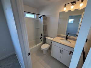 Full bath with shower / bath combo with shower curtain and vanity