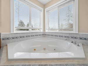 Full bath featuring a tub with jets