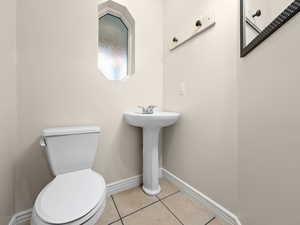 Bathroom featuring light tile patterned flooring and baseboards
