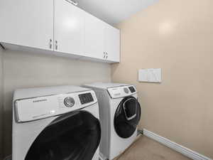 Laundry area with washing machine and clothes dryer included