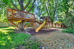 View of jungle gym featuring a fenced backyard and a wooden deck