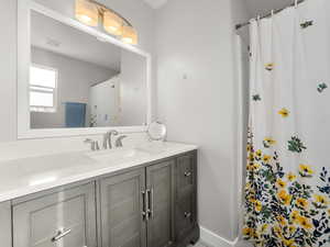 Full bath with vanity and curtained shower