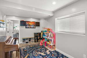 Rec room featuring wood finished floors and baseboards