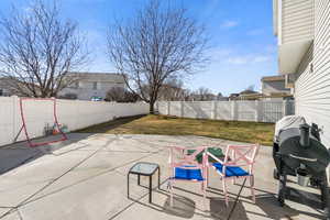 Fenced backyard with grilling area and a patio area