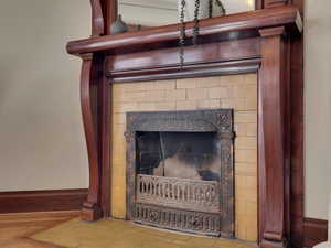Detailed view of baseboards and a fireplace
