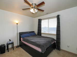 Bedroom featuring ceiling fan and light carpet