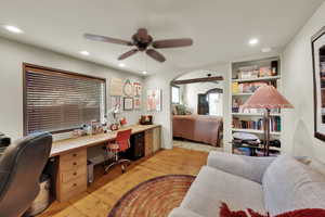 Office with a ceiling fan, light wood finished floors, recessed lighting, and built in features