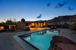 View of swimming pool with patio surround, a fenced backyard, and an outdoor living space