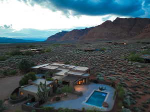 View from above of property featuring a mountainous background and a pool area