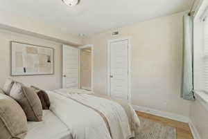 Bedroom featuring wood finished floors and baseboards