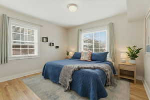 Bedroom featuring baseboards and wood finished floors