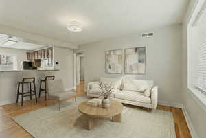 Living room with baseboards and light wood finished floors