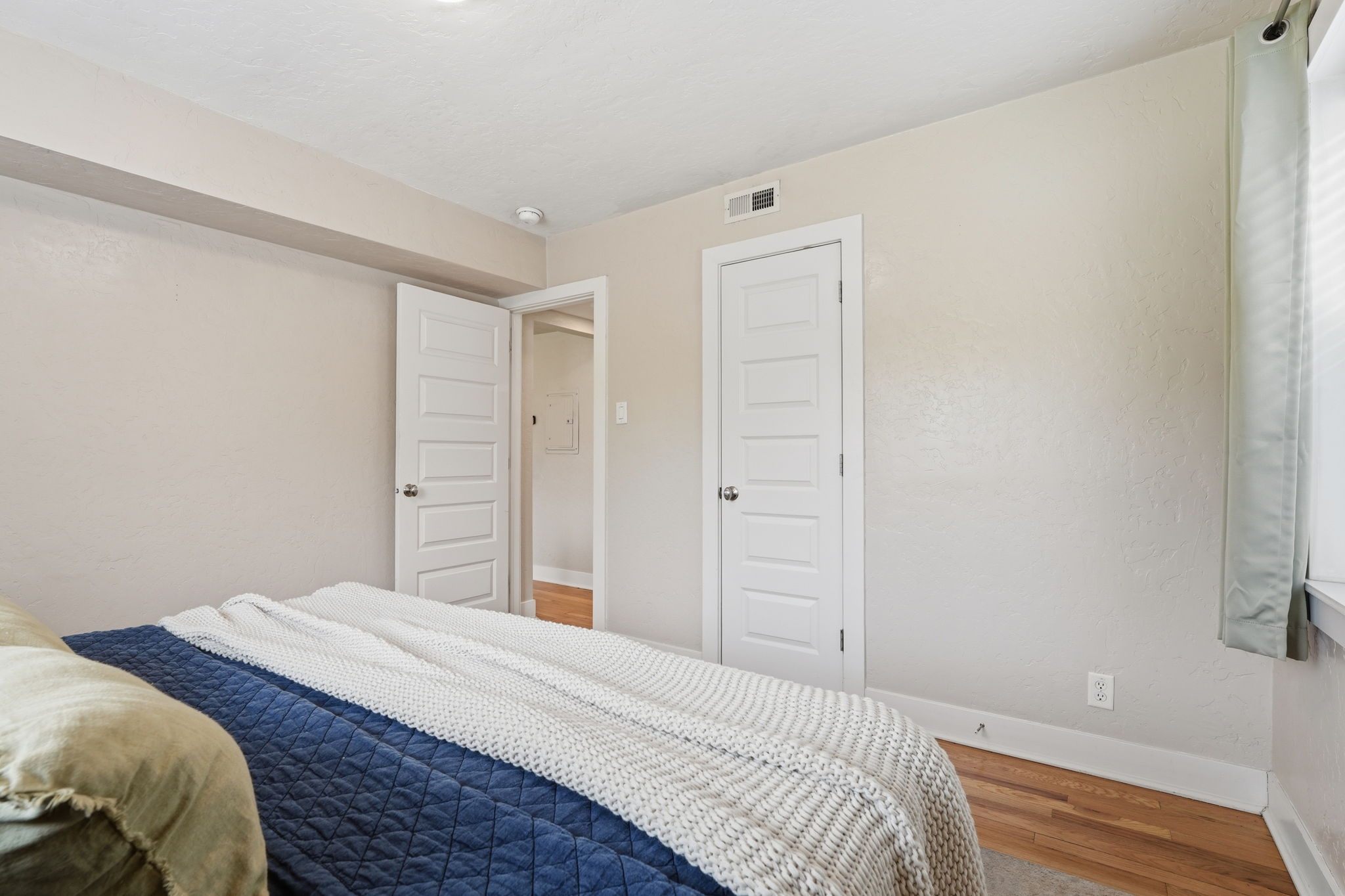 Bedroom featuring baseboards and wood finished floors
