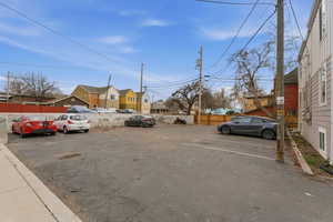 Uncovered parking lot featuring a residential view