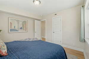 Bedroom featuring baseboards and light wood-type flooring