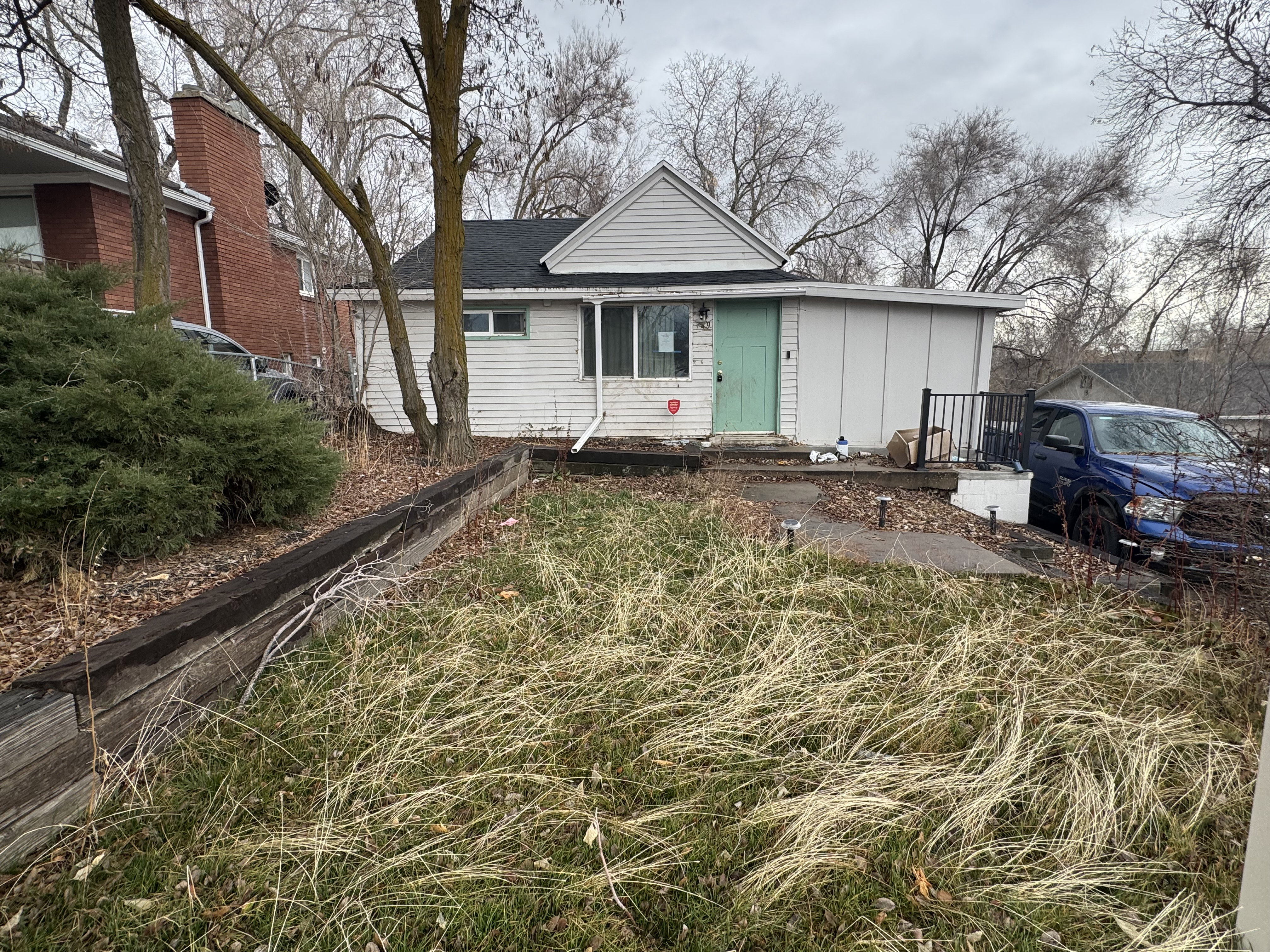 View of front of home with board and batten siding and a shingled roof