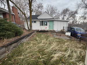View of front of home with board and batten siding and a shingled roof
