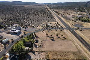 Aerial view of property and surrounding area featuring a mountainous background and rural landscape