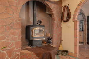 Detailed view of arched walkways, a textured wall, and a wood stove
