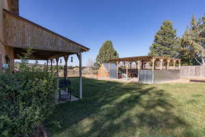 Fenced backyard with a patio area and an outbuilding