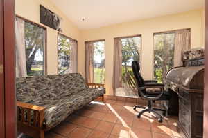 Home office featuring vaulted ceiling and tile patterned floors