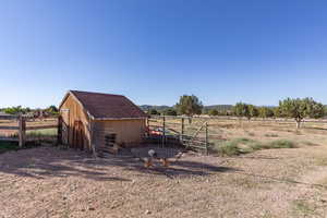 View of yard with a view of countryside, an outdoor structure, and exterior structure