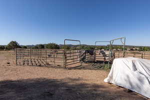 View of yard with a view of countryside, an outdoor structure, and an exterior structure