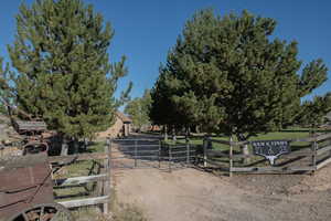View of dirt / gravel road with a gated entry