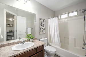 Bathroom featuring shower / bath combo and vanity