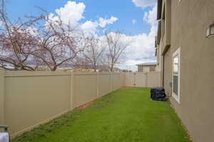 Fenced backyard featuring a gate