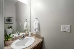 Half bathroom with vanity and toilet