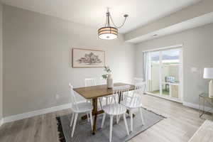 Dining room featuring light wood-style floors and baseboards