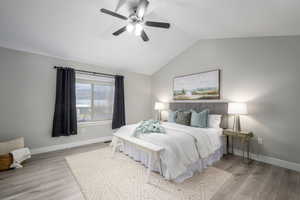 Primary Suite featuring vaulted ceiling, ceiling fan and beautiful views.