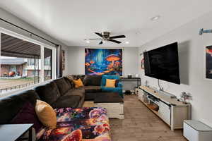 Living area featuring ceiling fan, light wood-type flooring, and recessed lighting
