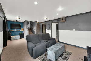 Living room featuring stairway and crown molding